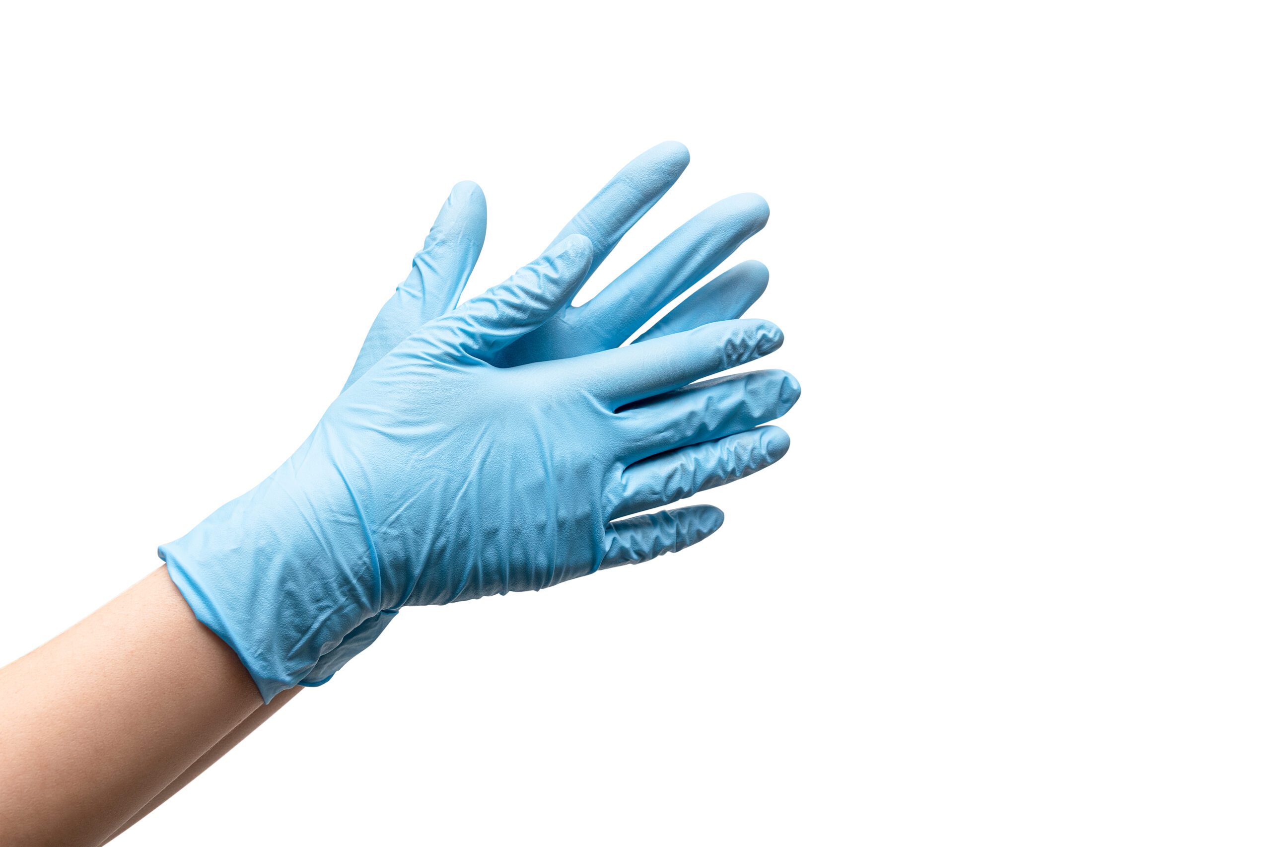 Female hands in disposable gloves on white background.